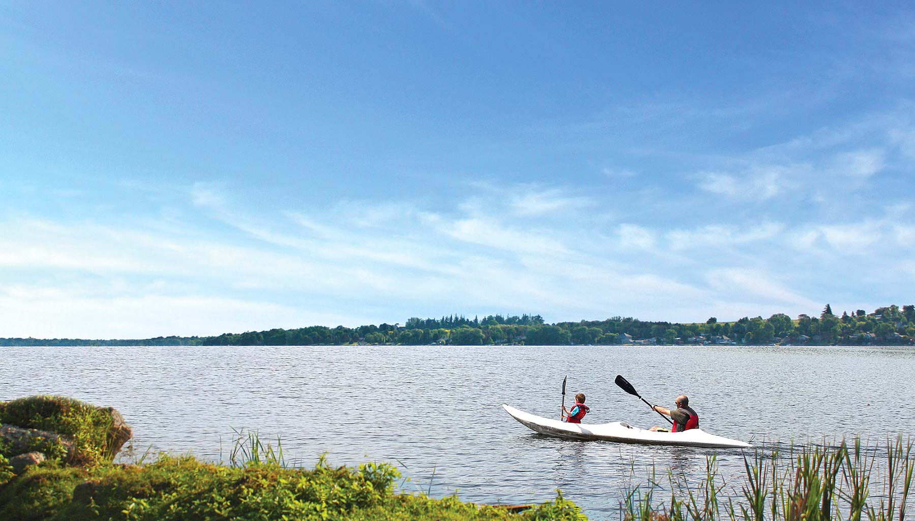 Father and son paddling on Lake Scugog.